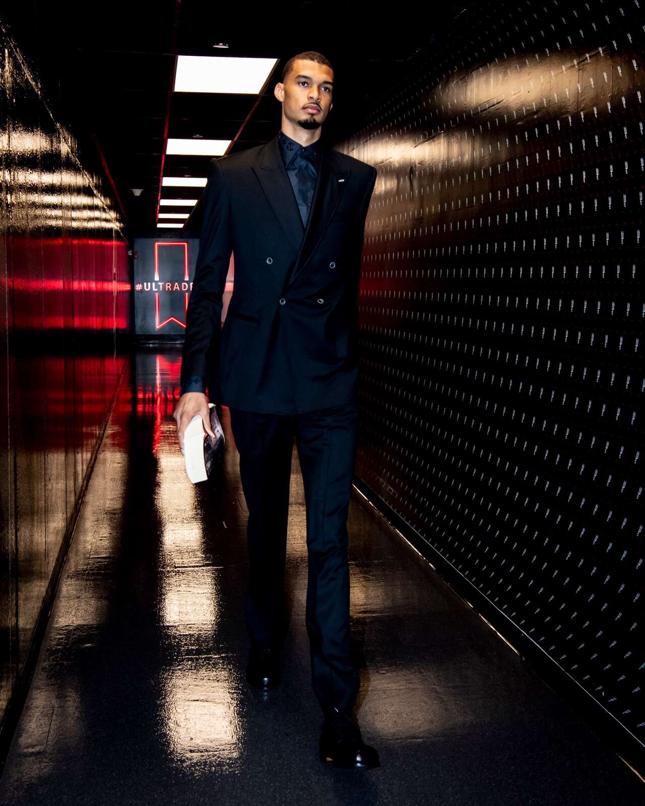 The Spurs all wore the same custom-tailored black suits Sunday night ...