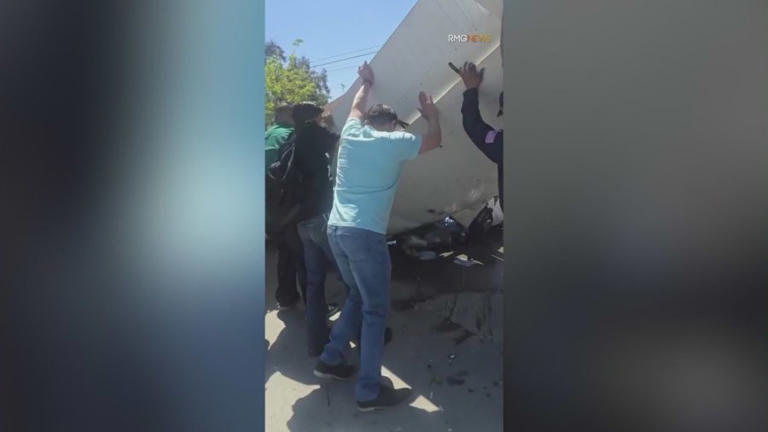 A group of bystanders was caught on camera lifting the wreckage of a small plane to free the pilot trapped inside after the aircraft went down in a parking lot in Pacoima, Calif. on Monday, April 20, 2026. (RMG News)