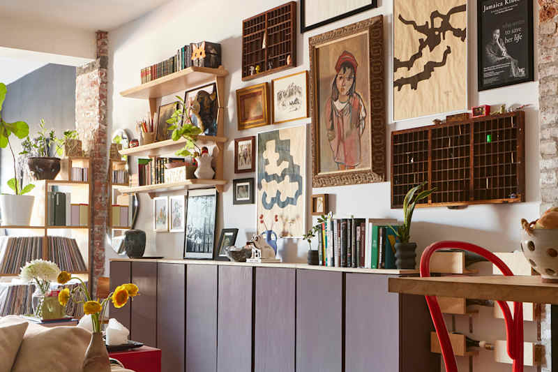 living room with purple IKEA cabinets and a full gallery wall of art