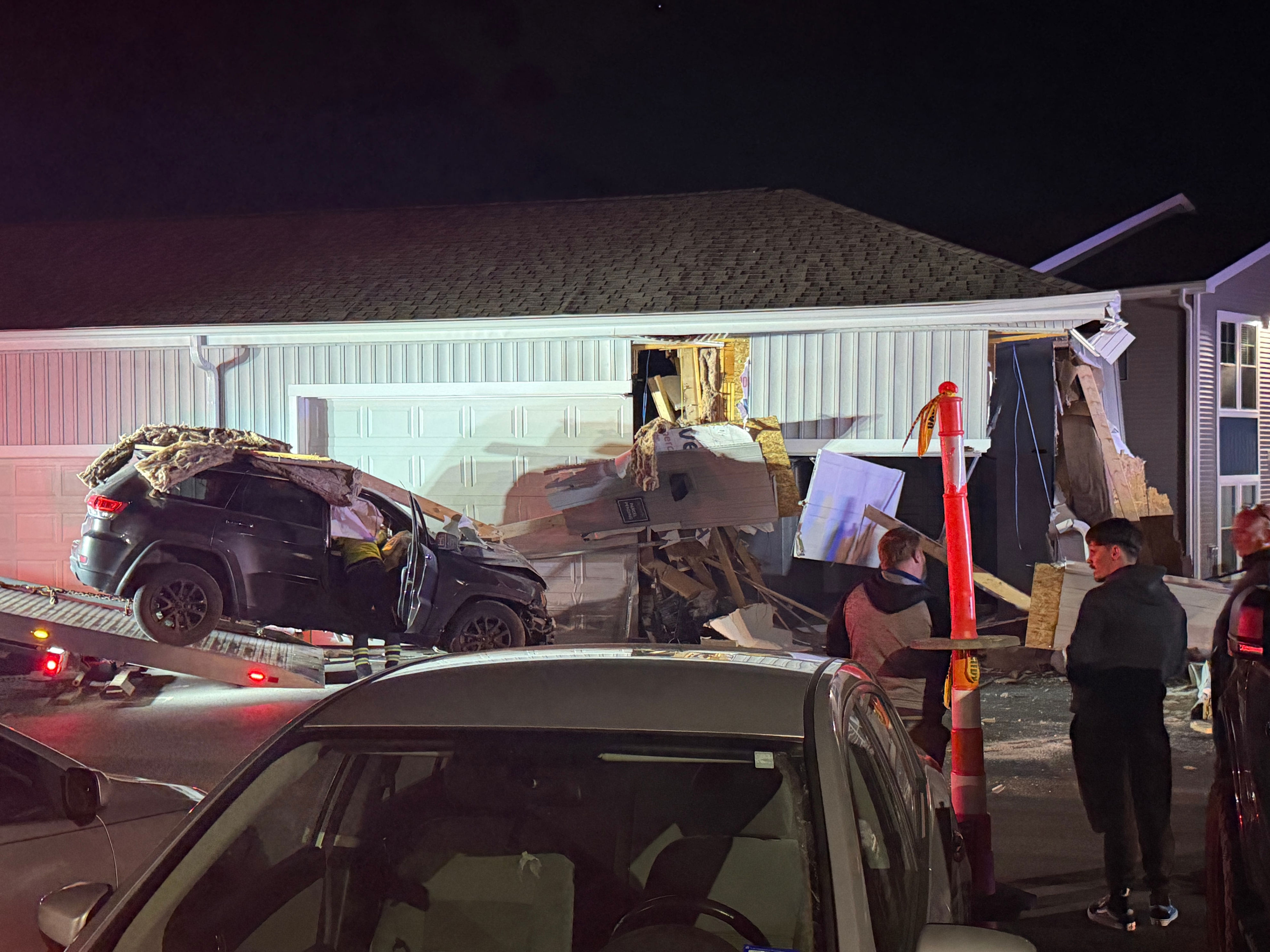 1 hospitalized after car slams into garage