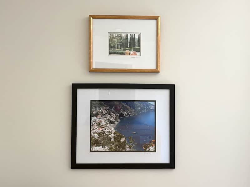 Vacation photos framed on wall.