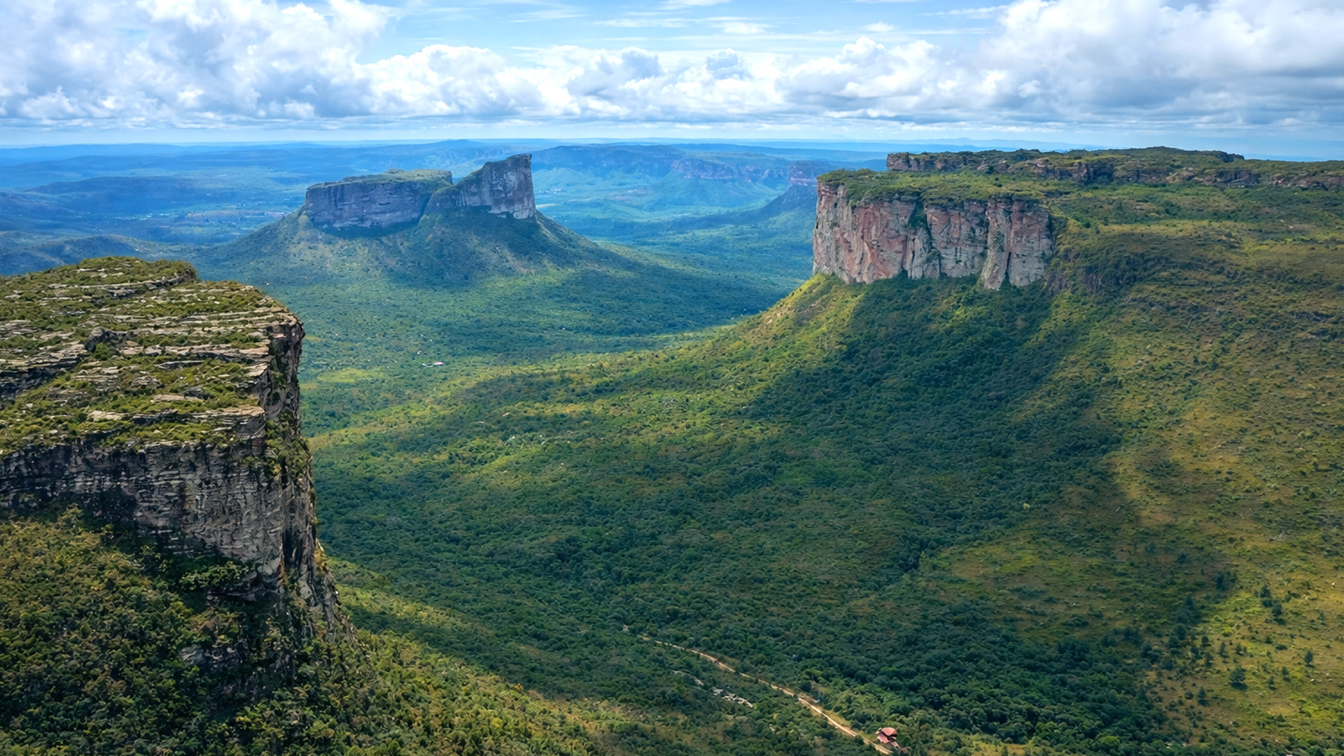 Massive cliffs rising above wide open valleys in Brazil