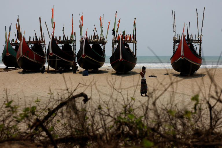 Faisal, a human trafficker, speaks on a mobile phone at a beach near a Rohingya refugee camp in Cox's Bazar, Bangladesh. Photo: Reuters