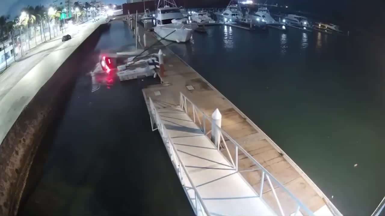Dramatic moment car screeches off quay and hits docked boats before ...
