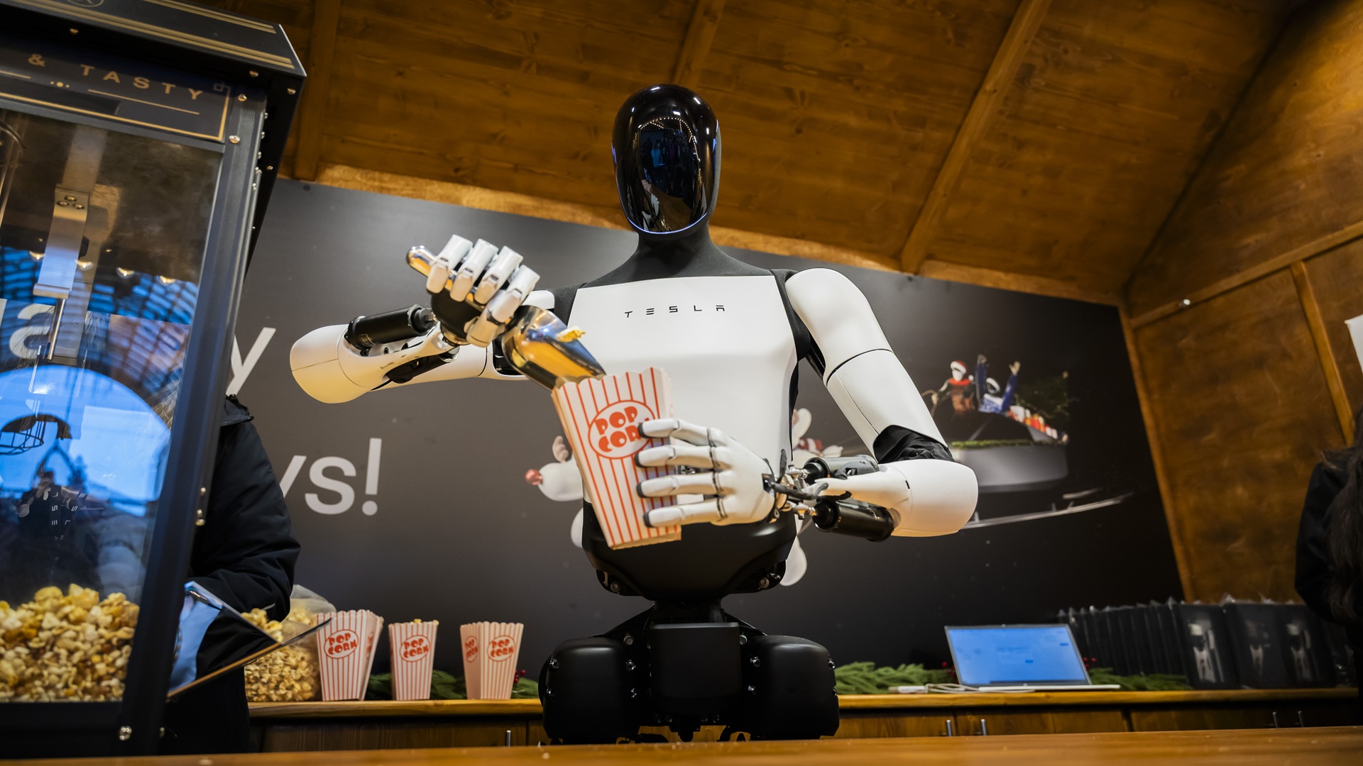 Tesla’s Optimus humanoid robot greets runners, poses for photos at ...