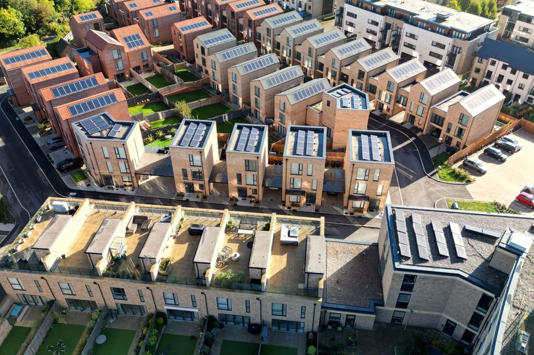 Aerial view of a newly built housing development with solar panels installed on all the rooftops