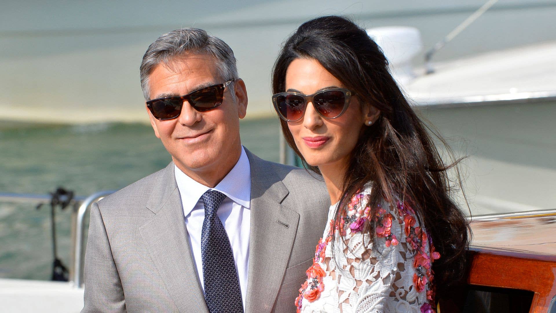 US actor George Clooney and his wife Amal Alamuddin leave the Aman Hotel on September 28, 2014 in Venice. Hollywood heartthrob George Clooney and Lebanese-British lawyer Amal Alamuddin married in Venice on Saturday September 27, 2014 before partying the night away with their A-list friends in one of the most high-profile celebrity weddings in years. "George Clooney and Amal Alamuddin were married today (September 27) in a private ceremony in Venice, Italy," Clooney spokesman Stan Rosenfield said. The announcement came as a surprise as the pair were not expected to officially tie the knot until Monday, though they are still tipped for a civil ceremony at the town hall to officialise the marriage under Italian law. AFP PHOTO / ANDREAS SOLARO (Photo by ANDREAS SOLARO / AFP) (Photo by ANDREAS SOLARO/AFP via Getty Images)