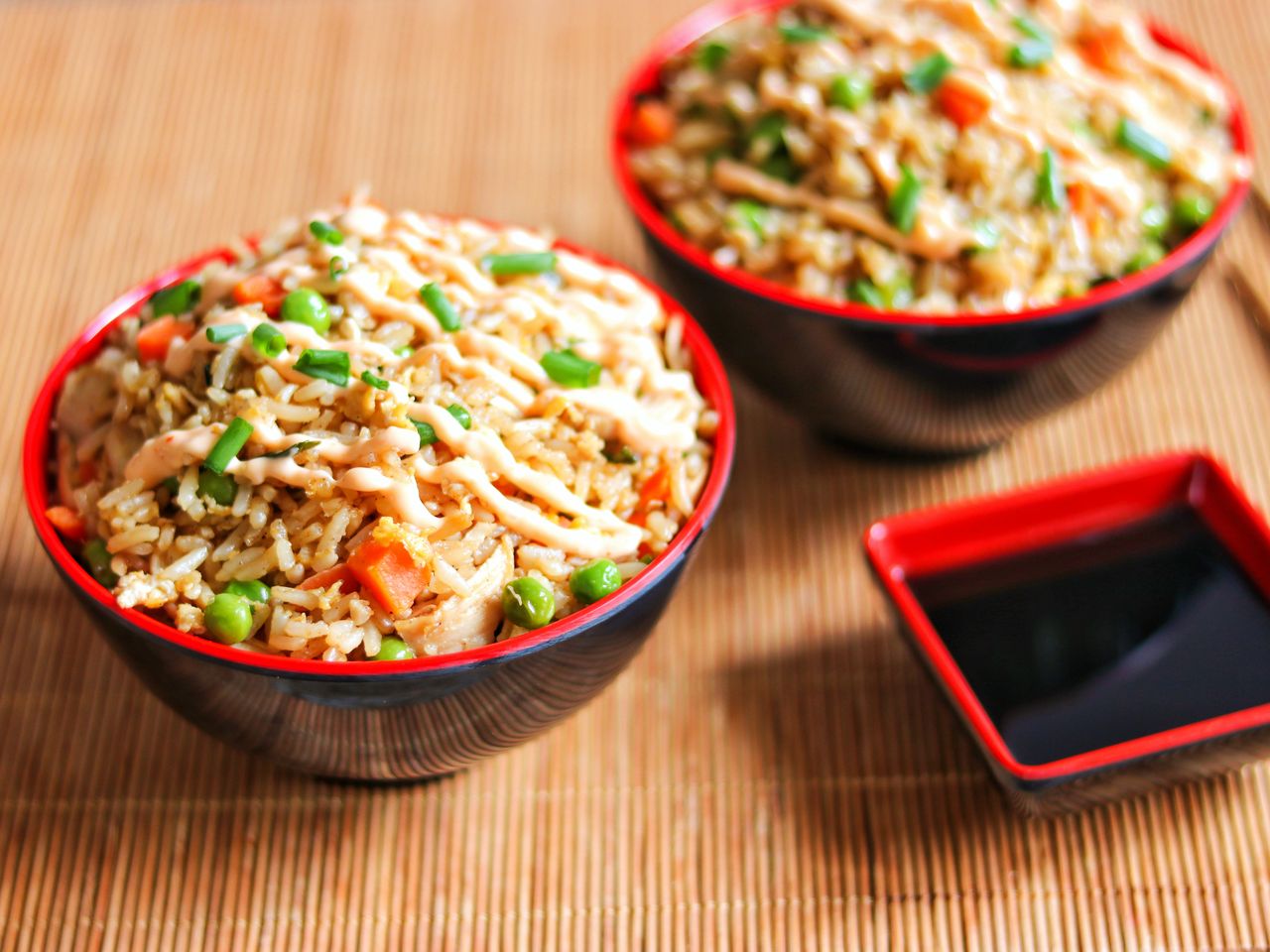 Classic chicken fried rice in Chinese bowls topped with scallions