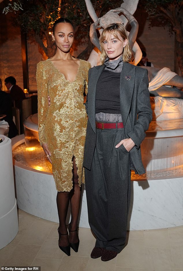 Zoe Saldana turns heads in a plunging lace dress as she joins stylish ...