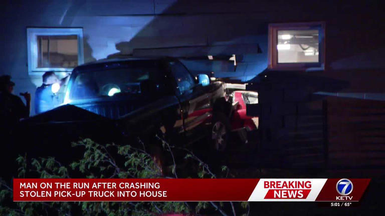 Police search for man after stolen truck crashes into Omaha home