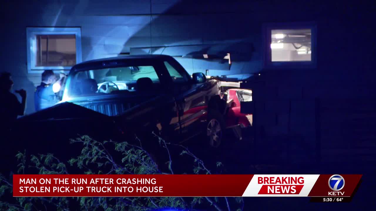 Police searching for driver after stolen truck hits home