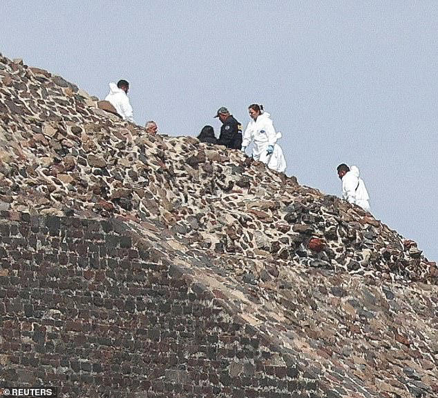 Tourists smile in front of Mexican pyramid with no idea that human ...