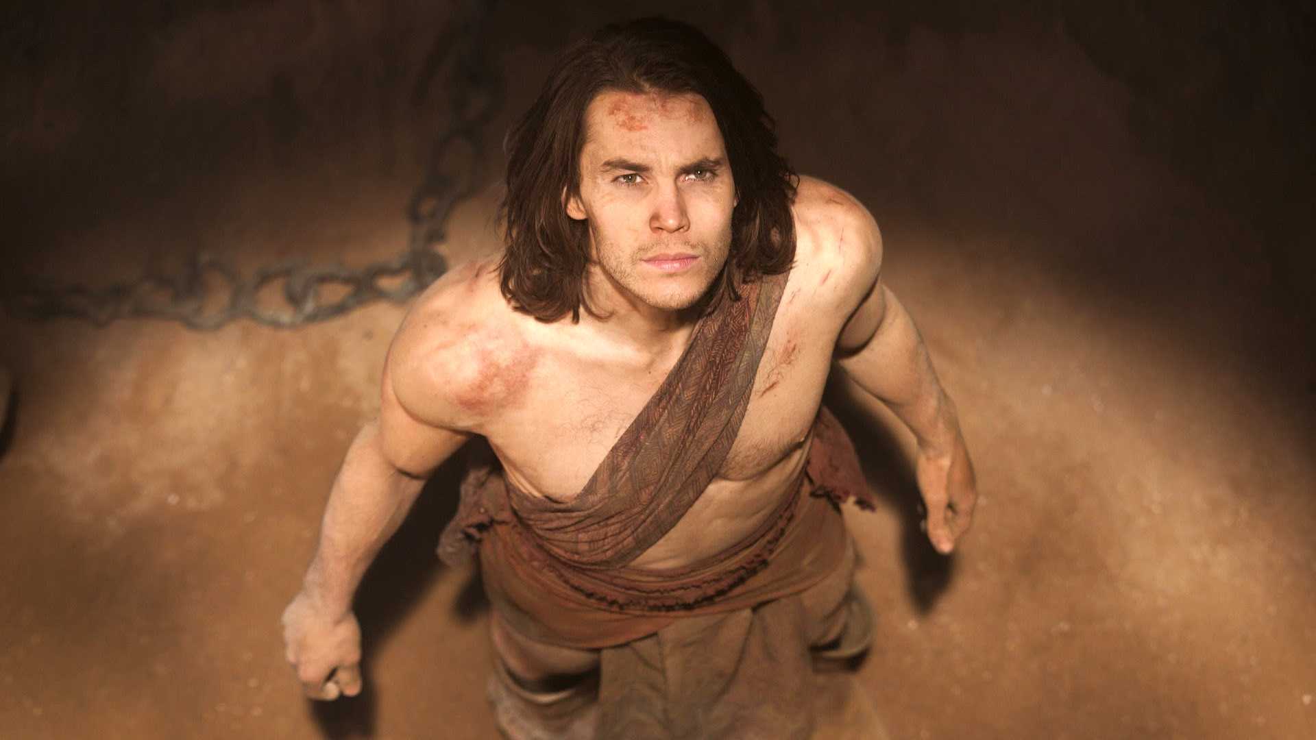 John Carter looks upward while balling up his fists in the John Carter movie