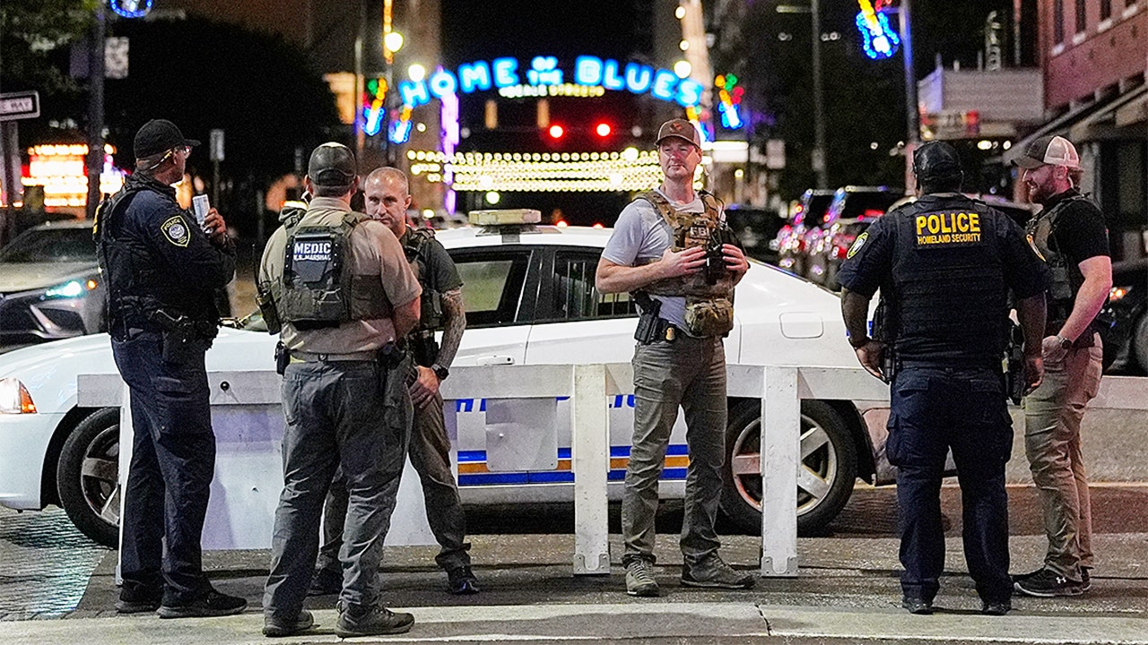 Federal law enforcement officers stand at the intersection of Beale Street and North Second Street in Memphis, Tenn., on Oct. 8, 2025, amid President Donald Trump's deployment of the National Guard.