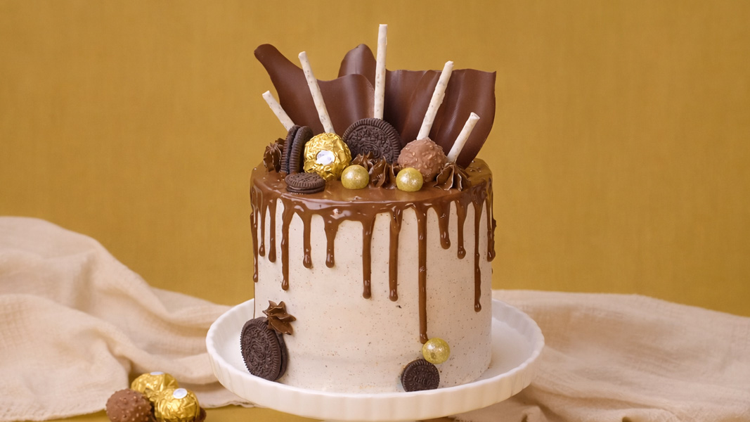 Chocolate drip cake with cookies and candy topping