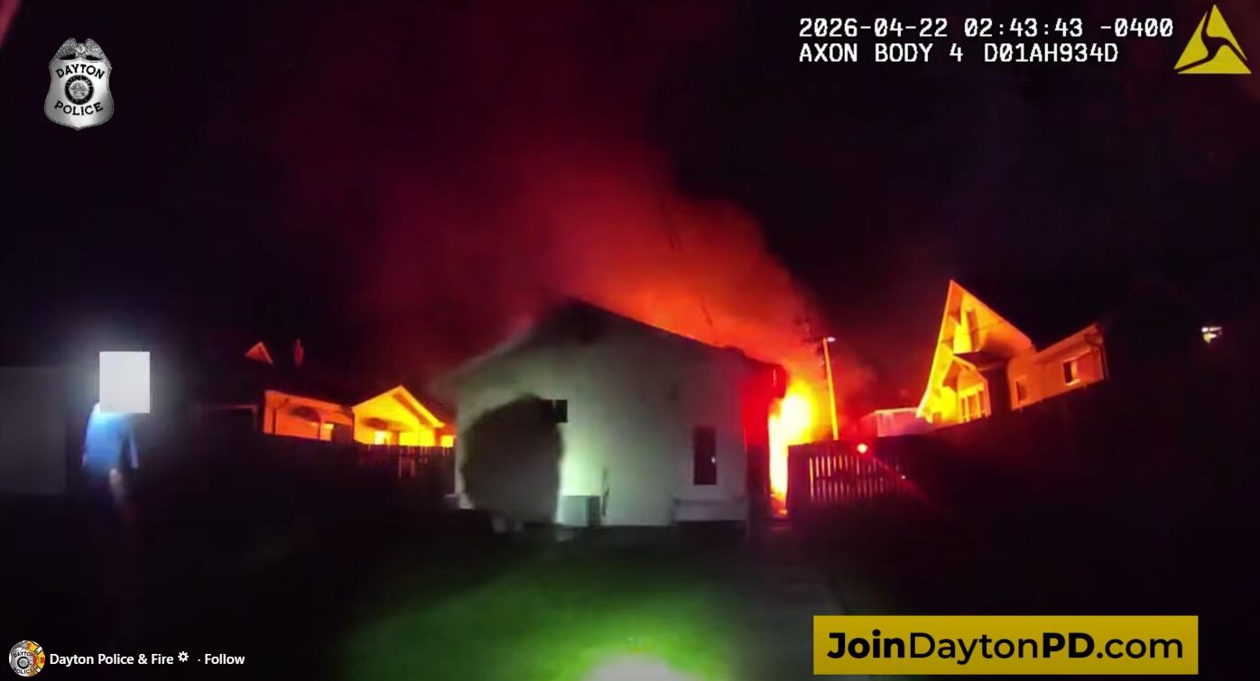 Police assist couple from house fire in Dayton neighborhood