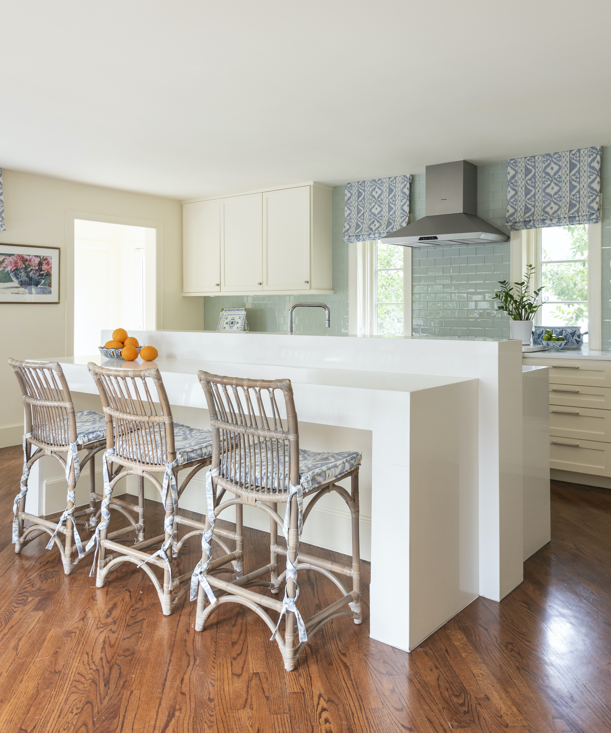 kitchen with white island and three stools