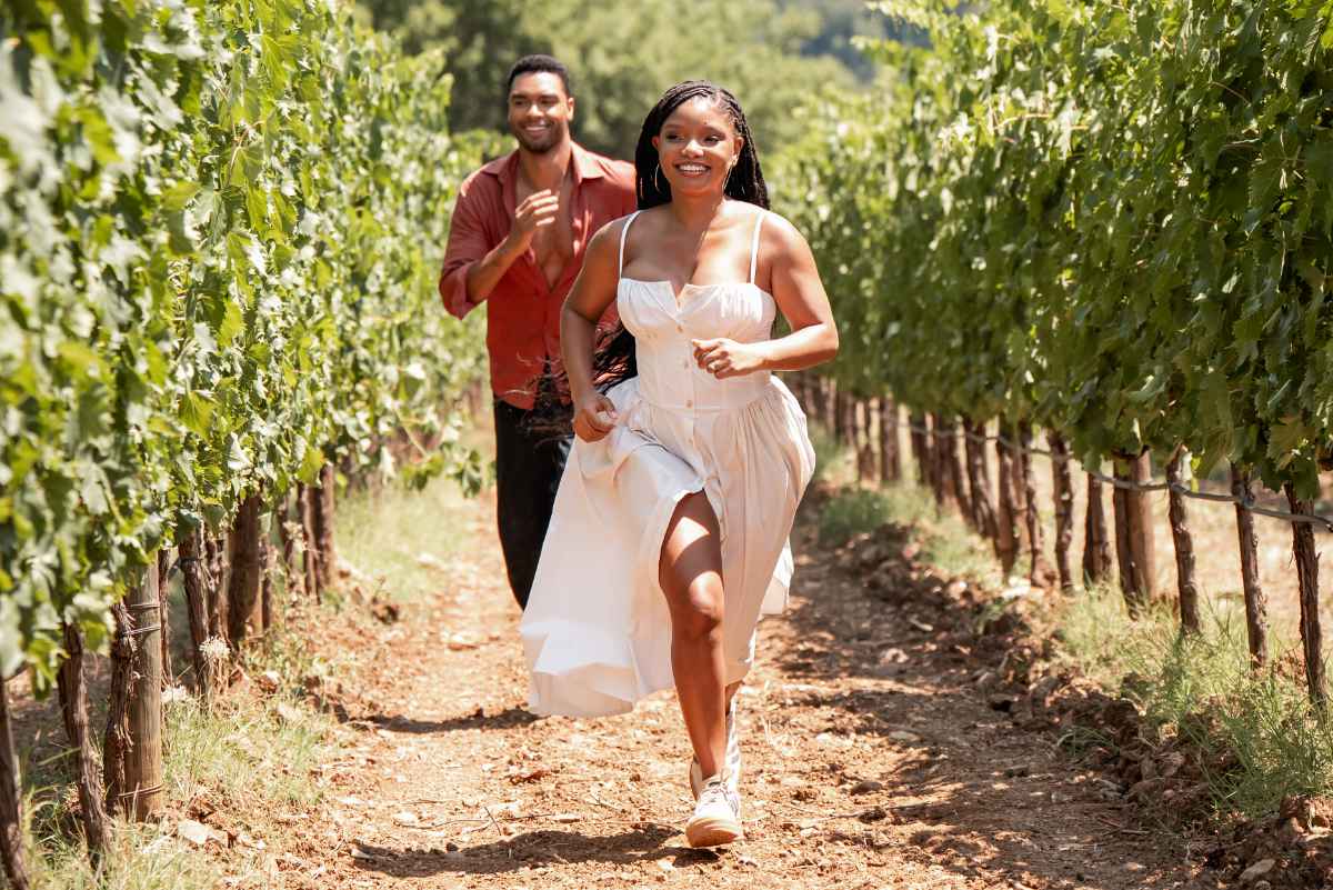 Regé-Jean Page chases halle bailey through grape fields at a winery in tuscany in the movie you me and tuscany