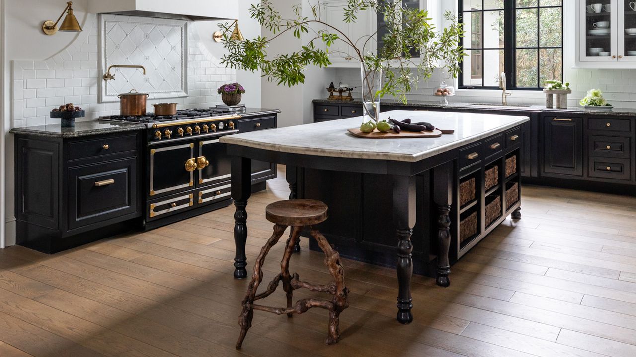 kitchen with island in black with wooden stool and floors