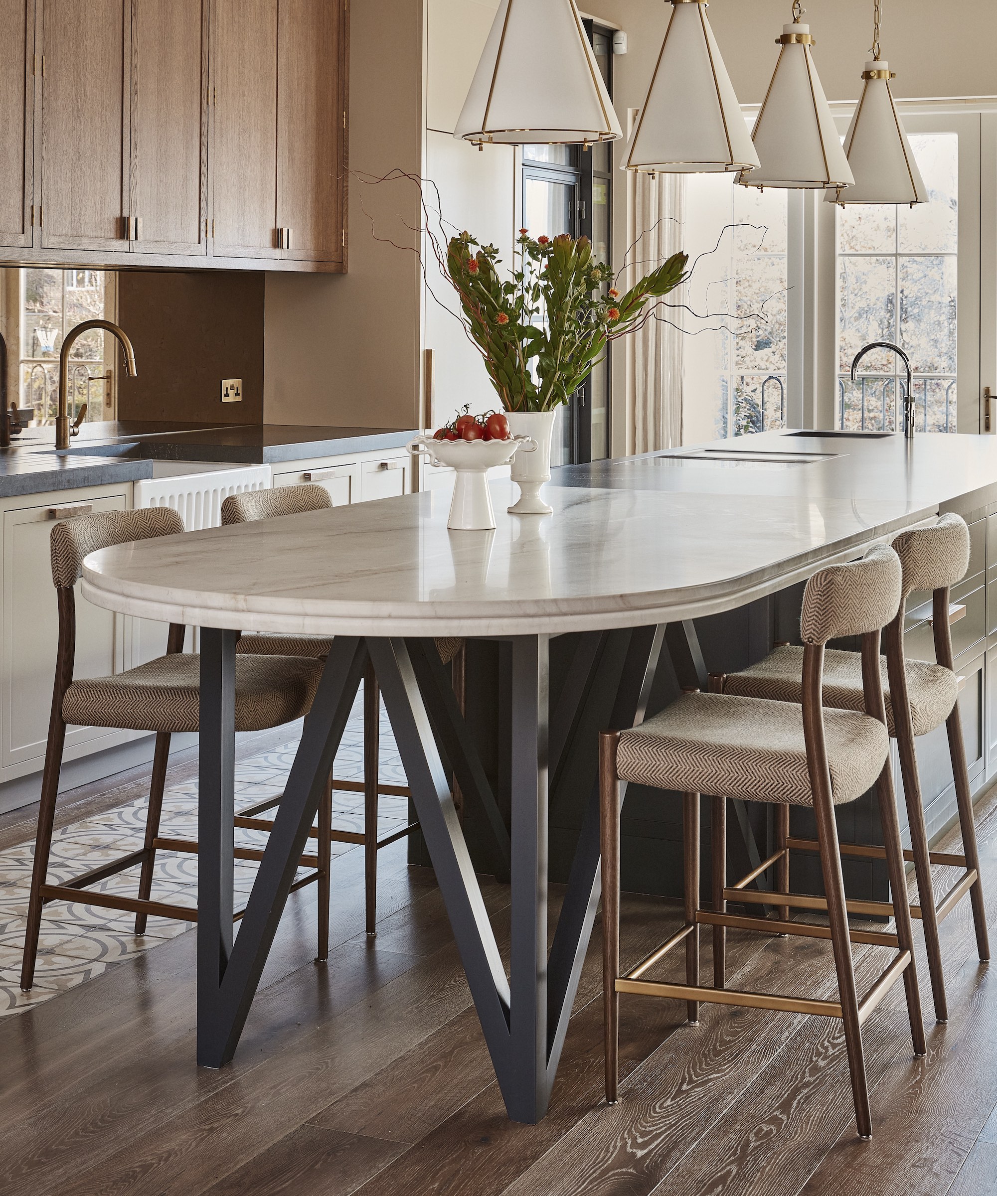 kitchen with island and four stools and wooden floors