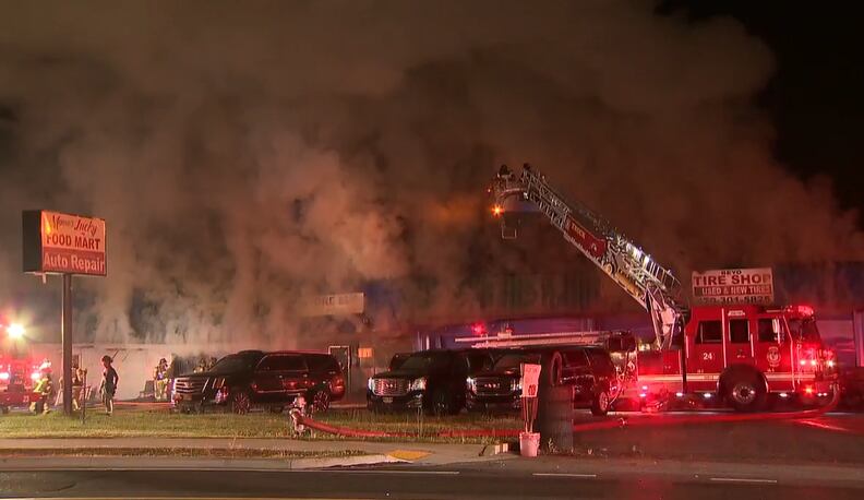 Roof collapses as fire tears through pair of businesses