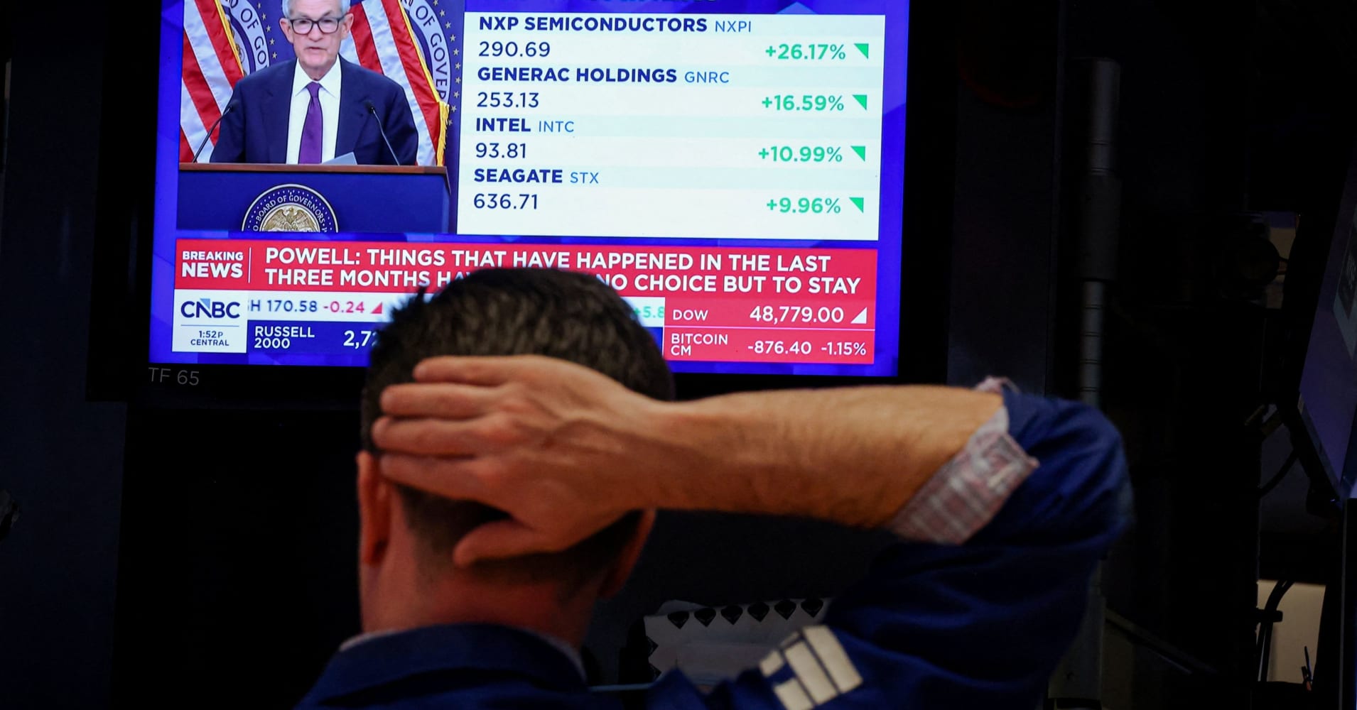 A trader works, as a screen broadcasts a news conference by U.S. Federal Reserve Chair Jerome Powell following the Fed rate announcement, on the floor of the New York Stock Exchange (NYSE) in New York City, U.S., April 29, 2026.