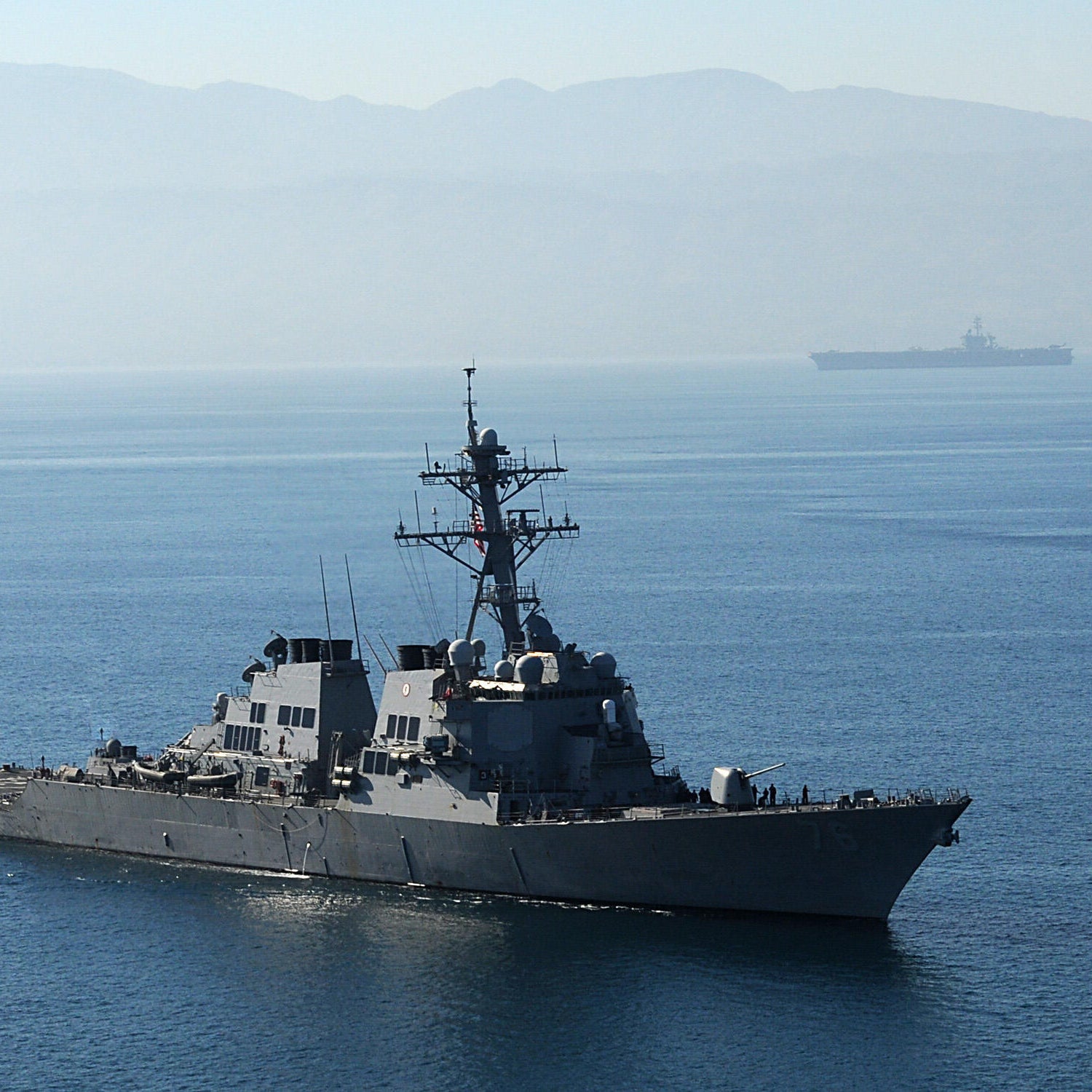 The guided-missile destroyer USS Higgins (DDG 76), foreground, and Nimitz-class aircraft carrier USS Carl Vinson (CVN 70) arrive off the coast of Haiti on January 15, 2009 in Port-Au-Prince, Haiti.