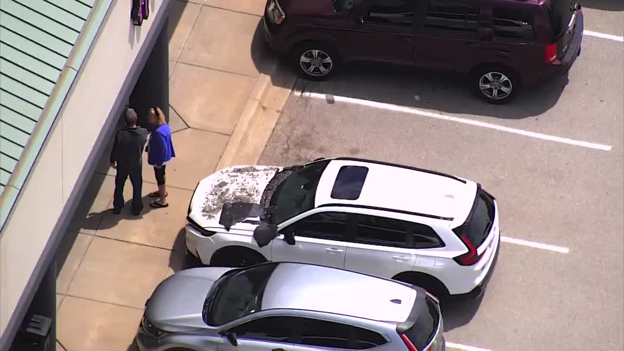 Sky 5 flies over scene where car crashes into nail salon