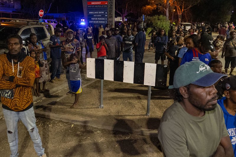 Locals gather outside the Alice Springs Hospital on Thursday night.
