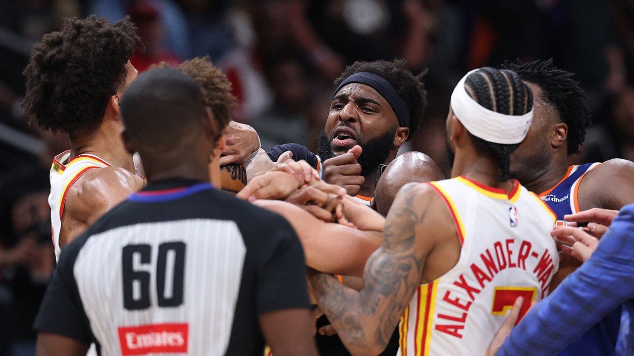 Mitchell Robinson of the New York Knicks and Jalen Johnson of the Atlanta Hawks fight during the second quarter of Game Six in the first round of the NBA Eastern Conference playoffs at State Farm Arena in Atlanta, Ga., on April 30, 2026.