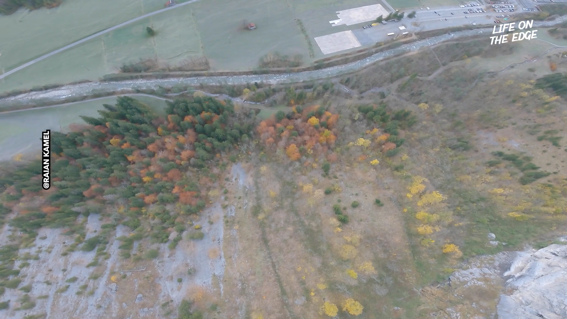 Wingsuit base jump through Alpine valley