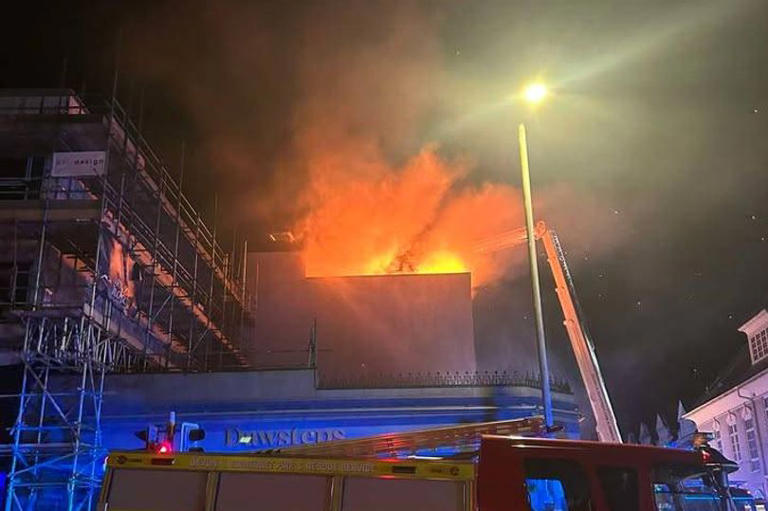 Huge fire rips through roof terrace of apartment building as residents ...