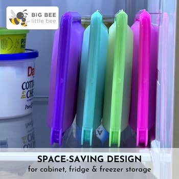 Reusable food storage bags stand upright in a fridge beside other containers, promoting space-saving design for cabinet, fridge, and freezer storage