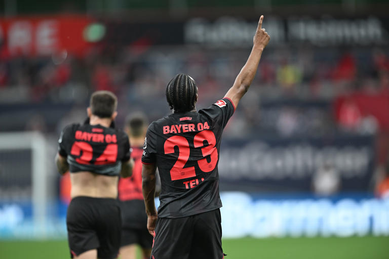 Leverkusen's Nathan Tella, left, celebrates after scoring his side's second goal during the German Bundesliga soccer match between Bayer Leverkusen and RB Leipzig in Leverkusen, Germany, Saturday, May 2, 2026. (Fabian Strauch/dpa via AP)