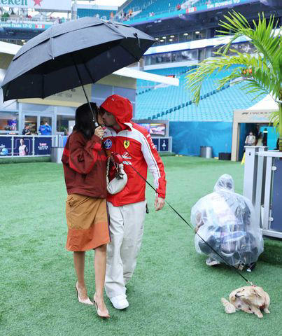 Charles and Alexandra Leclerc kiss in the paddock ahead of the 2026 Miami Grand Prix. Credit: Hector Vivas - Formula 1/Formula 1 via Getty