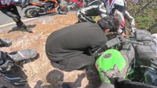 Motorcyclist slides into crashed bike during turn