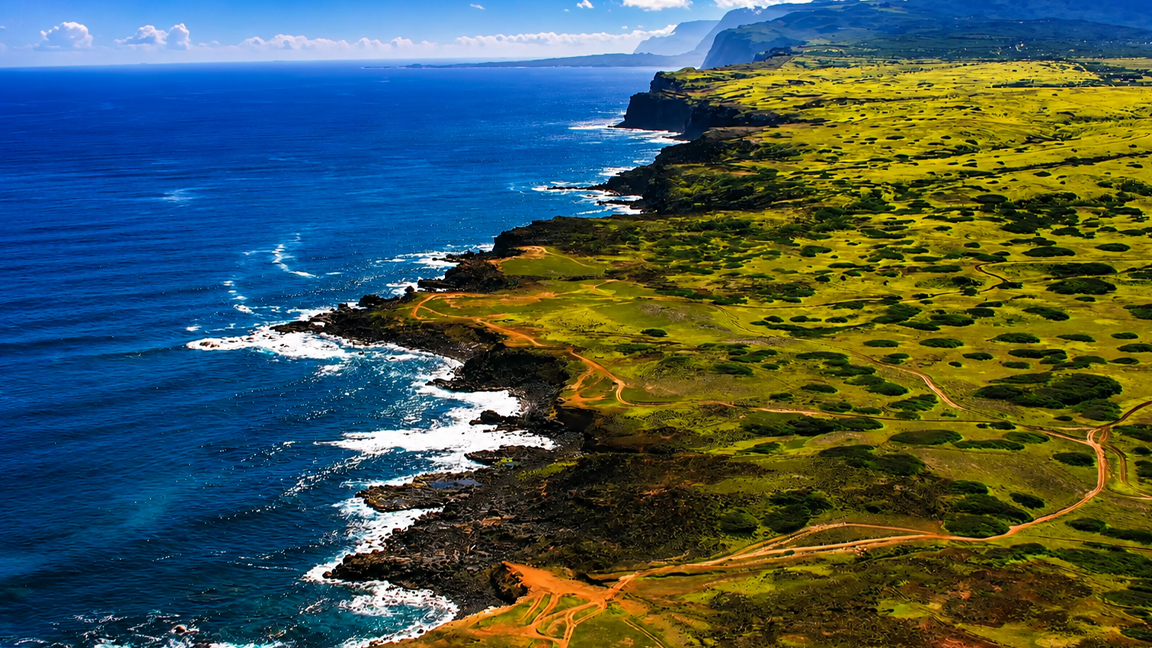 Beautiful coastal landscape with waves and green hills