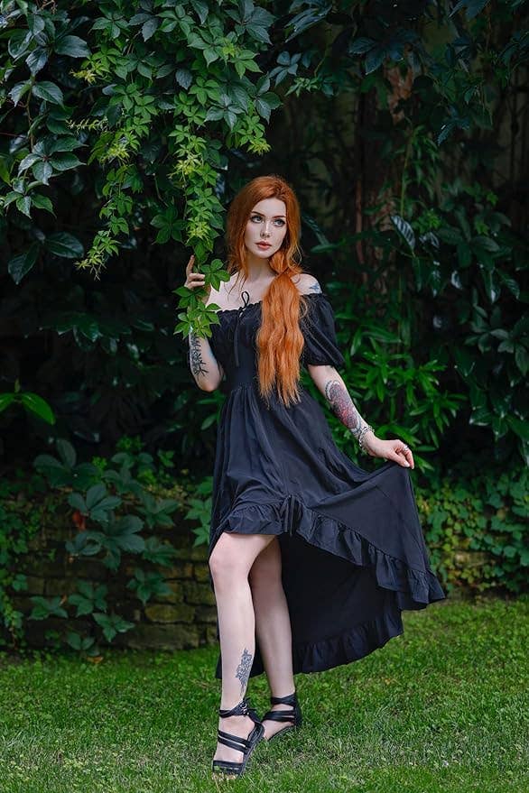 model in an off-the-shoulder black dress with ruffled hem