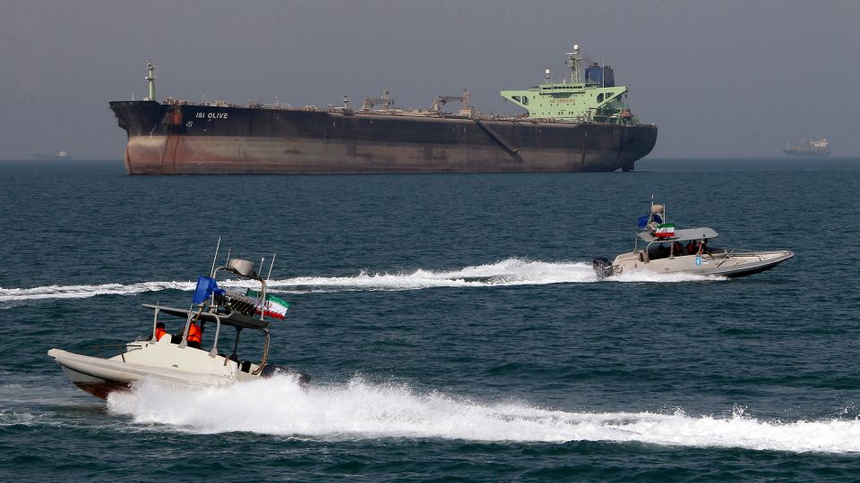 Iranian Revolutionary Guard small boats are pictured cruising past an oil tanker off the port of Bandar Abbas, southern Iran, in July 2012. - Atta Kenare/AFP/Getty Images