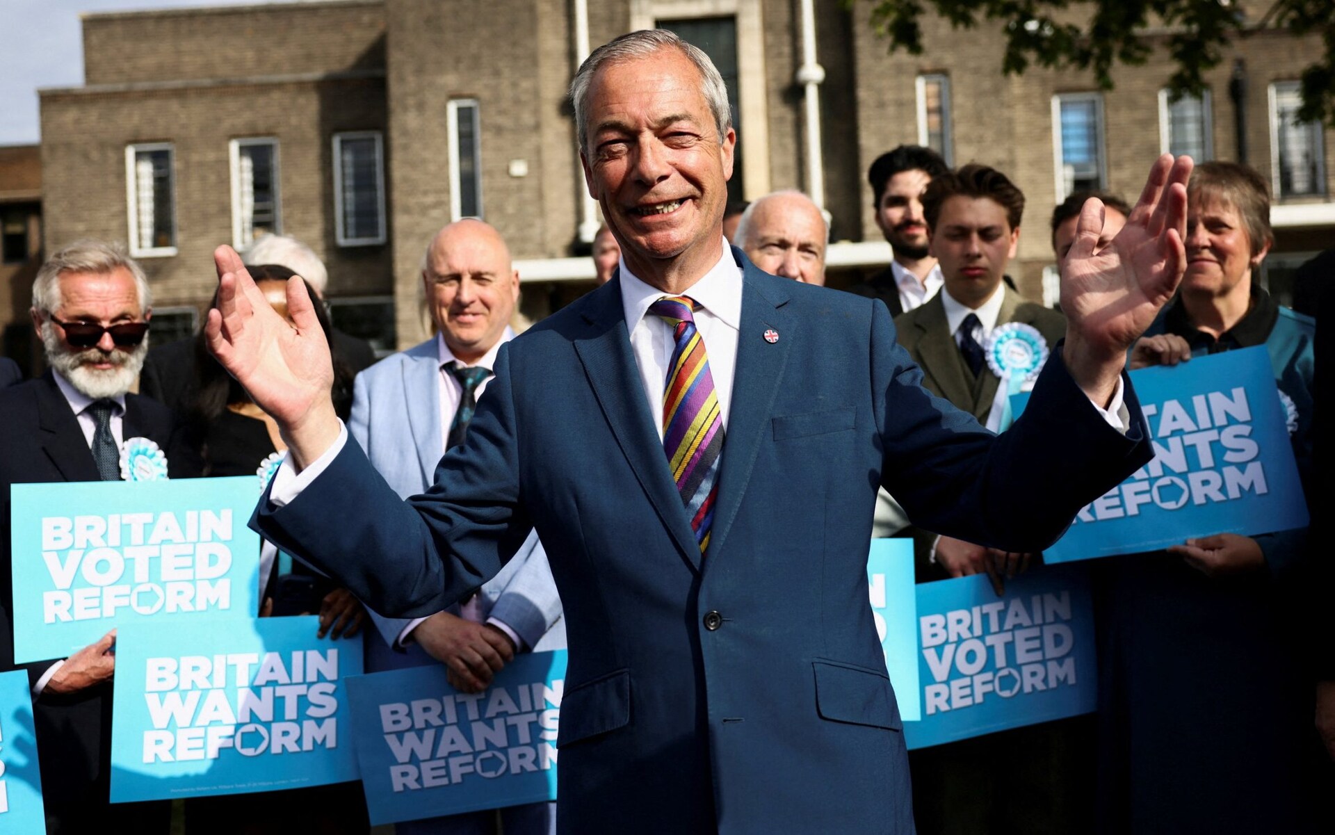 Nigel Farage reacts next to newly elected councillors at Havering Town Hall