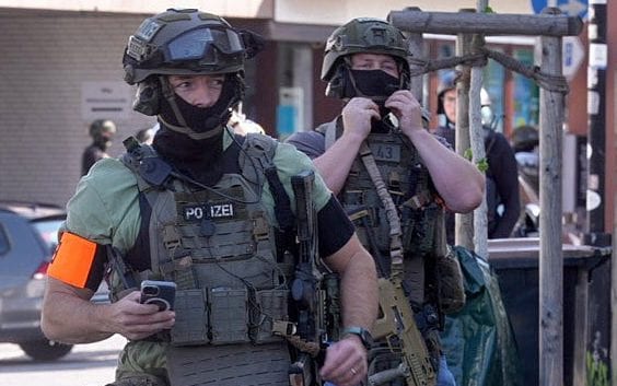 Manhunt under way after hostages seized in bank robbery