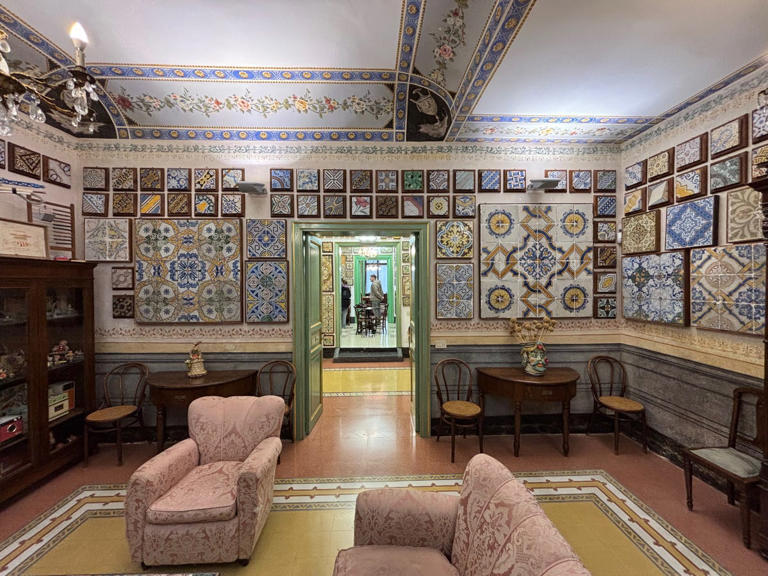 interior of a room featuring ornate tile displays and vintage furniture