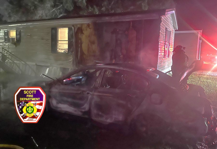 Vehicle fire in Scott causes damage to nearby home, no injuries