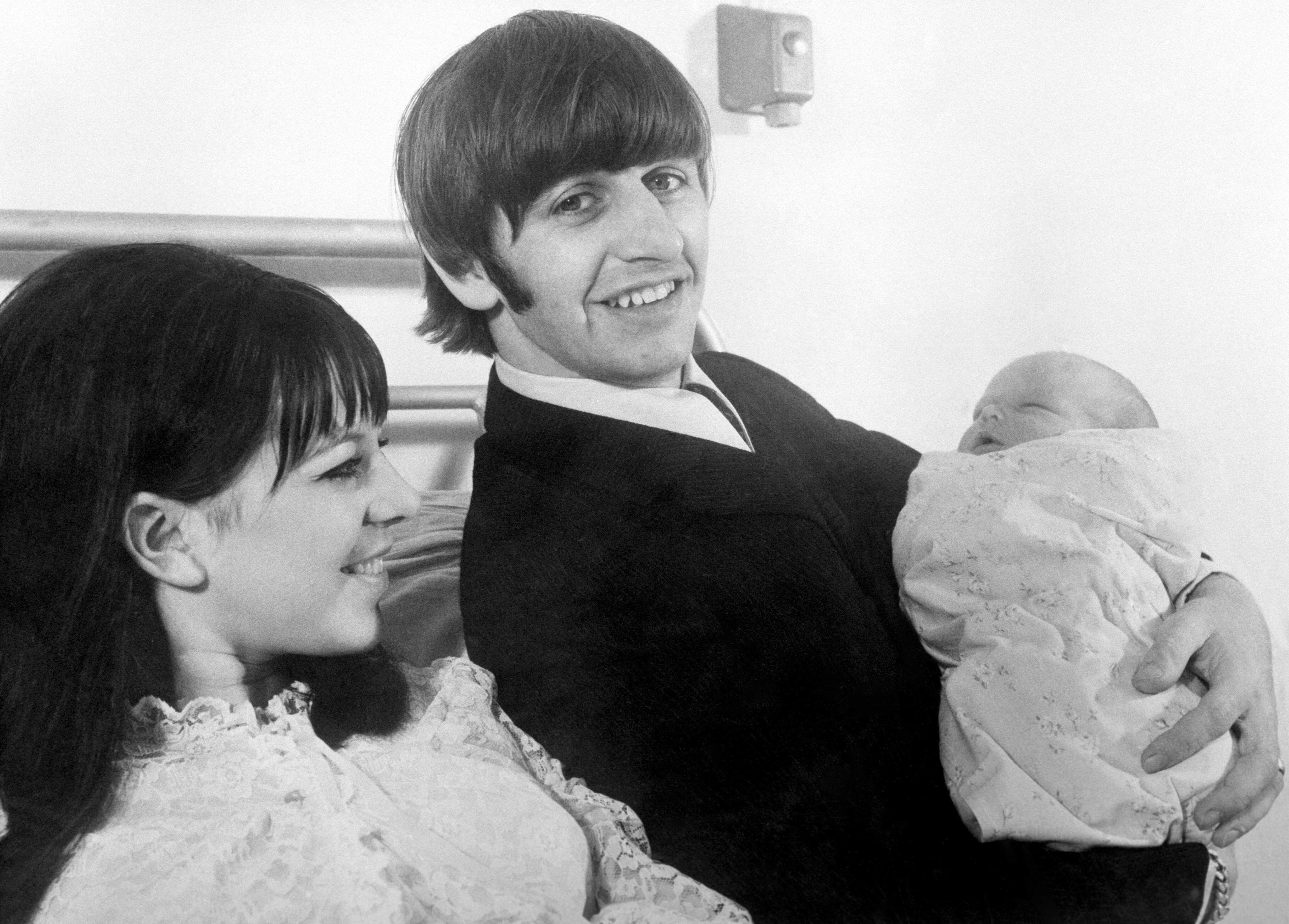 1965-Beatles drummer Ringo Starr with his 19-year-old wife Maureen, and their first child Zak, at Queen Charlotte's Hospital in London. (Photo by PA Images via Getty Images)