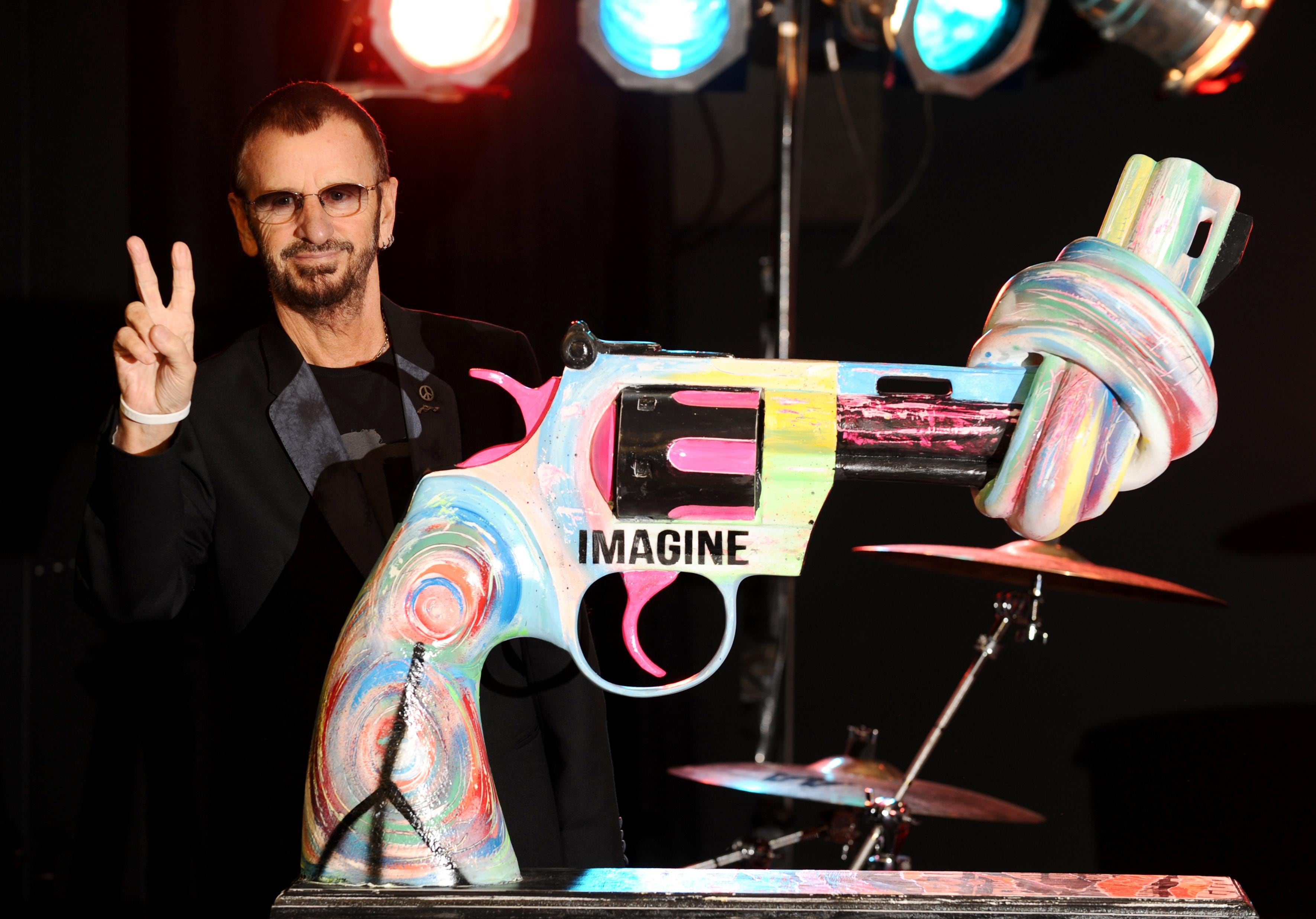 2011 - Ringo Starr with his 'Knotted Gun' statue at the Gibson Guitar Studio, in central London. (Photo by Dominic Lipinski/PA Images via Getty Images)