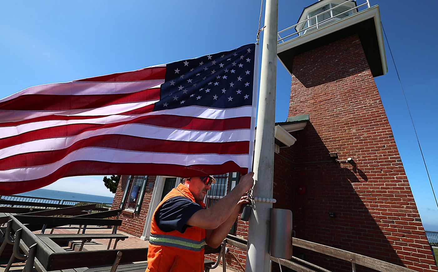 Photos | City work flies new flag at Mark Abbott Memorial Lighthouse in ...