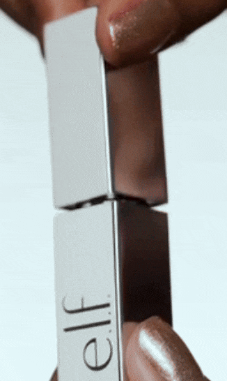 Close-up of hands opening an e.l.f. Cosmetics lipstick case, showing the product in a sleek metallic design