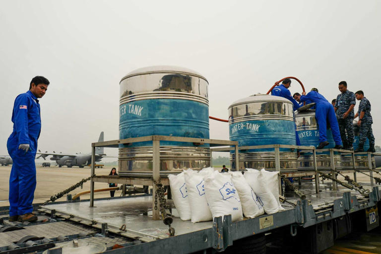 Officials mix sodium chloride and water for cloud seeding at a military base in Subang, Malaysia in 2019. Photo: AFP