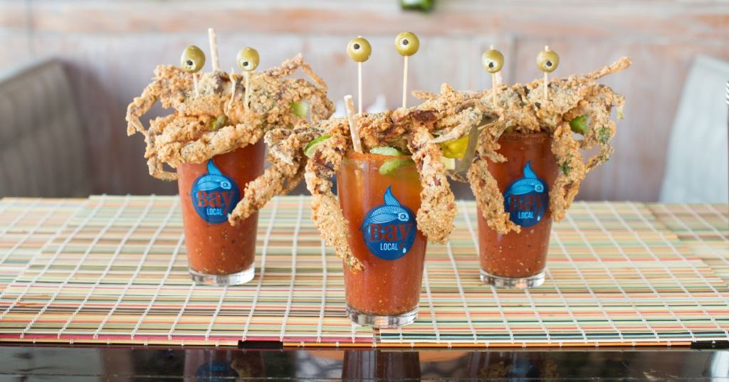 Three bloody mary cocktails with fried crabs on top at Bay Local Eatery in Chic's Beach - Hidden Waterfront Town VA