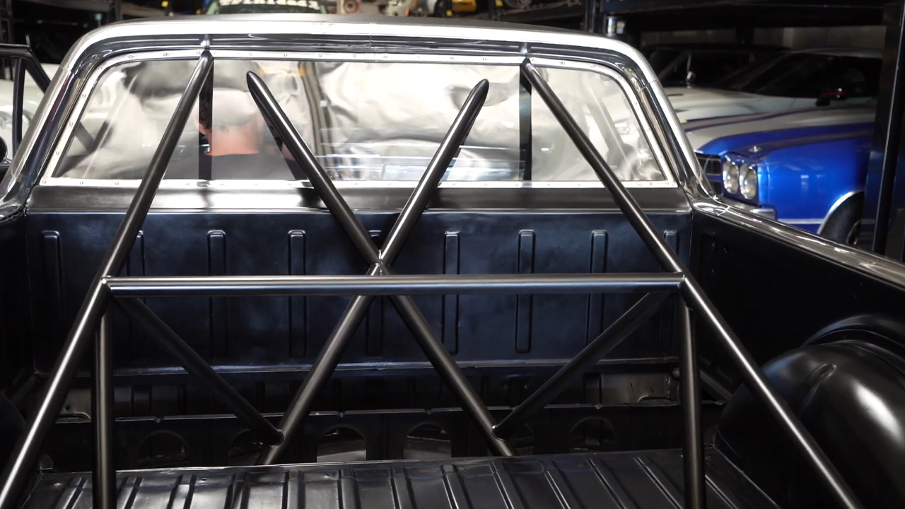 Handmade roll cage design piercing through this classic rear glass